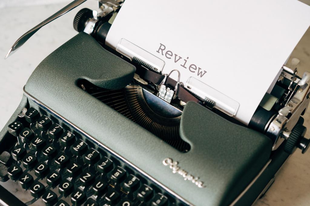 photo of a typewriter with "review" typed on the paper