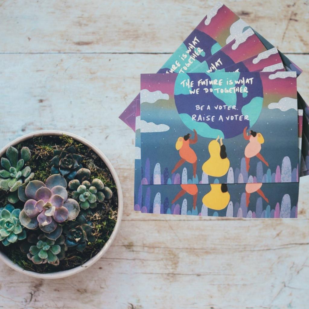 [IMAGE DESCRIPTION: A photo of a potted succulent plant next to a neat pile of postcards.]